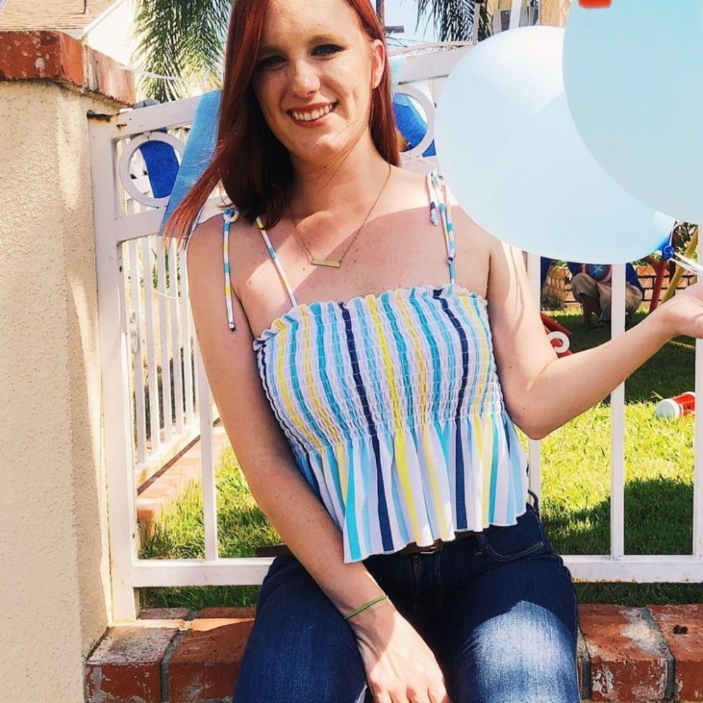 Wild Fable smocked tank top adjustable straps by tying in bow
Peplum like